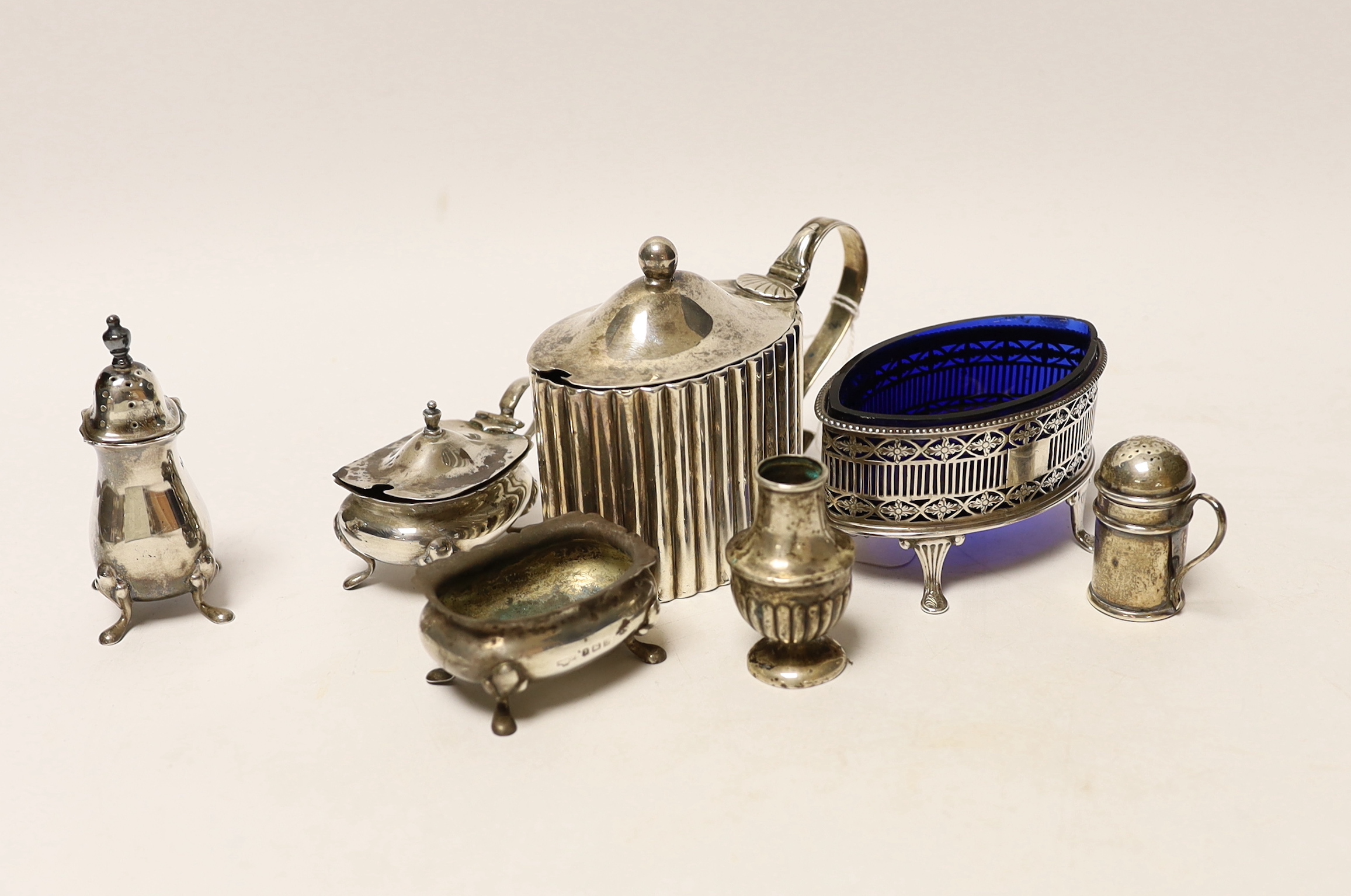 A George III silver mustard, by Peter & Jonathan Bateman, London, 1790 and six other minor silver condiments.